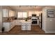 Bright kitchen featuring white cabinetry, stainless steel appliances, and a center island with seating at 4032 E Jojoba Rd, Phoenix, AZ 85044