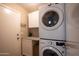 Efficient laundry room with stacked washer/dryer and ample cabinet space at 4032 E Jojoba Rd, Phoenix, AZ 85044