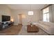 Bright living room with a large window, neutral sofa, and a modern media console at 4032 E Jojoba Rd, Phoenix, AZ 85044