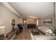 Bright, open-concept living room featuring wood flooring, a modern chandelier, and stylish furniture, creating an inviting atmosphere at 4032 E Jojoba Rd, Phoenix, AZ 85044