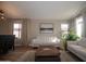 Comfortable living room area featuring a modern sofa, neutral decor, and large windows, creating a bright and airy atmosphere at 4032 E Jojoba Rd, Phoenix, AZ 85044