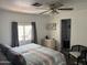 Bright main bedroom with a ceiling fan, large window, and an ensuite bathroom at 4065 E University Dr # 556, Mesa, AZ 85205