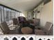 Inviting covered porch furnished with comfortable chairs and a cozy rug for relaxing at 4065 E University Dr # 556, Mesa, AZ 85205