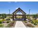 Community gazebo featuring stone columns, picnic tables, and landscaped surroundings with views of homes and basketball court at 4159 E Kolin Ln, San Tan Valley, AZ 85143