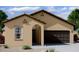 Charming one-story home with a two-car garage, neutral stucco, arched entryway, and low-maintenance landscaping at 4159 E Kolin Ln, San Tan Valley, AZ 85143