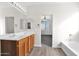 Bathroom featuring double sinks, wood cabinets, and access to a bathtub at 43524 W Bailey Dr, Maricopa, AZ 85138