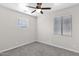 Bedroom featuring gray carpet and two windows at 43524 W Bailey Dr, Maricopa, AZ 85138