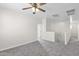 Spacious bedroom featuring a ceiling fan, neutral paint, and plush carpet at 43524 W Bailey Dr, Maricopa, AZ 85138