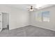 Bright bedroom showcasing a ceiling fan and natural light from the window at 43524 W Bailey Dr, Maricopa, AZ 85138