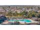 An aerial view of a community pool area featuring palm trees and ample lounge space at 43524 W Bailey Dr, Maricopa, AZ 85138