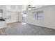 Bright living room featuring updated flooring, neutral paint, and modern ceiling fan at 43524 W Bailey Dr, Maricopa, AZ 85138