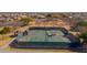 Aerial shot of community tennis courts, meticulously maintained and ready for play at 43524 W Bailey Dr, Maricopa, AZ 85138