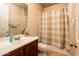 Neutral-toned bathroom with classic sink and vanity, a standard toilet, and a shower with a patterned curtain at 4488 N 155Th Ave, Goodyear, AZ 85395