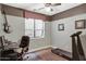 A well-lit bedroom featuring hardwood floors, neutral paint, treadmill, and a window with blinds, creating a comfortable space at 4488 N 155Th Ave, Goodyear, AZ 85395