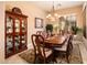 Formal dining room featuring a large table, decorative hutch, and elegant chandelier at 4488 N 155Th Ave, Goodyear, AZ 85395