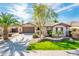 Inviting single-story home showcasing a well-maintained lawn, lush landscaping, and a spacious two-car garage at 4488 N 155Th Ave, Goodyear, AZ 85395