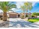 Charming single-story home with a well-manicured lawn, mature landscaping, and a spacious three-car garage at 4488 N 155Th Ave, Goodyear, AZ 85395