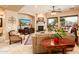 Inviting living room with a fireplace, comfortable seating, and bright natural light at 4488 N 155Th Ave, Goodyear, AZ 85395