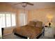 Bedroom with a window, textured walls, ceiling fan, and queen bed at 455 W Gary Ave, Gilbert, AZ 85233