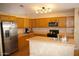 Traditional kitchen features wood cabinetry, stainless steel appliances, and tile flooring at 455 W Gary Ave, Gilbert, AZ 85233