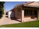 Rear exterior shot shows a covered patio, shed for storage, and beautiful lawn at 455 W Gary Ave, Gilbert, AZ 85233