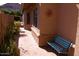 Private outdoor patio space with tiled flooring, sun decor, and a blue wrought iron bench at 455 W Gary Ave, Gilbert, AZ 85233