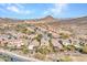 Aerial view of a home in a desert community showing tile roofs, landscaping, desert vegetation and mountain views at 5137 W Quail Track Dr, Phoenix, AZ 85083