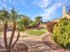 Lush backyard with manicured lawn, mature trees, and brick pavers in a well-maintained space at 5137 W Quail Track Dr, Phoenix, AZ 85083