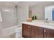 Bathroom featuring tile floors, single sink vanity, and shower-tub combo at 5137 W Quail Track Dr, Phoenix, AZ 85083