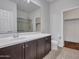 Modern bathroom featuring a spacious vanity, framed mirror, and a glass-enclosed shower at 5137 W Quail Track Dr, Phoenix, AZ 85083