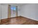 Bedroom featuring wood-look floors, neutral paint, and patterned curtains at 5137 W Quail Track Dr, Phoenix, AZ 85083