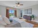 Bedroom featuring view of the backyard, patterned curtains, and wood-look floors at 5137 W Quail Track Dr, Phoenix, AZ 85083