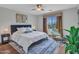 Cozy main bedroom featuring a ceiling fan, ensuite seating area, and a patterned rug at 5137 W Quail Track Dr, Phoenix, AZ 85083