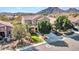 A home's exterior with a desert landscape, including a green lawn and mature shade trees at 5137 W Quail Track Dr, Phoenix, AZ 85083