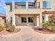 Two-story home with balcony features manicured landscaping and a brick paved patio at 5137 W Quail Track Dr, Phoenix, AZ 85083