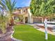 Inviting home exterior featuring a lush lawn, mature landscaping, and a welcoming entryway at 5137 W Quail Track Dr, Phoenix, AZ 85083