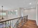 Second floor hallway features hardwood floors and a decorative wrought iron railing at 5137 W Quail Track Dr, Phoenix, AZ 85083