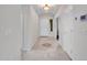 Clean, neutral hallway with tiled floor, elegant lighting and modern thermostat for comfort at 5137 W Quail Track Dr, Phoenix, AZ 85083