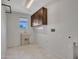 Laundry room equipped with cabinets, a utility sink, and a window at 5137 W Quail Track Dr, Phoenix, AZ 85083