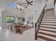 Open-concept living room with high ceilings, natural light, and a staircase at 5137 W Quail Track Dr, Phoenix, AZ 85083