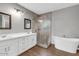 Beautifully updated bathroom with double vanity, soaking tub, and tiled walk-in shower at 514 W Desert Ln, Phoenix, AZ 85041