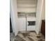 Interior laundry closet with white washer and dryer and bi-fold doors at 5228 N 15Th Dr, Phoenix, AZ 85015