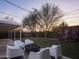 Outdoor backyard featuring seating, green synthetic grass, ambient lights, and bike rack at 6114 N 8Th St, Phoenix, AZ 85014