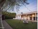 Backyard with swing set, black grill, green synthetic grass, and string lights at 6114 N 8Th St, Phoenix, AZ 85014