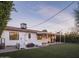 A beautiful home backyard with a seating area with synthetic grass and string lights at 6114 N 8Th St, Phoenix, AZ 85014