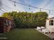 View of a backyard with a seating area, synthetic grass, string lights, and bike rack at 6114 N 8Th St, Phoenix, AZ 85014