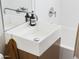 Bathroom featuring a modern sink, sleek vanity, and a bathtub with stylish fixtures and a coordinated towel at 6114 N 8Th St, Phoenix, AZ 85014