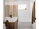 Inviting bathroom featuring a modern sink, sleek vanity, and a bathtub with a shower curtain at 6114 N 8Th St, Phoenix, AZ 85014