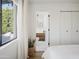 Bright bedroom featuring hardwood floors and a peek into the en-suite bathroom at 6114 N 8Th St, Phoenix, AZ 85014