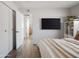 Bedroom featuring wood floors, built in shelving, and a television mounted on the wall at 6114 N 8Th St, Phoenix, AZ 85014